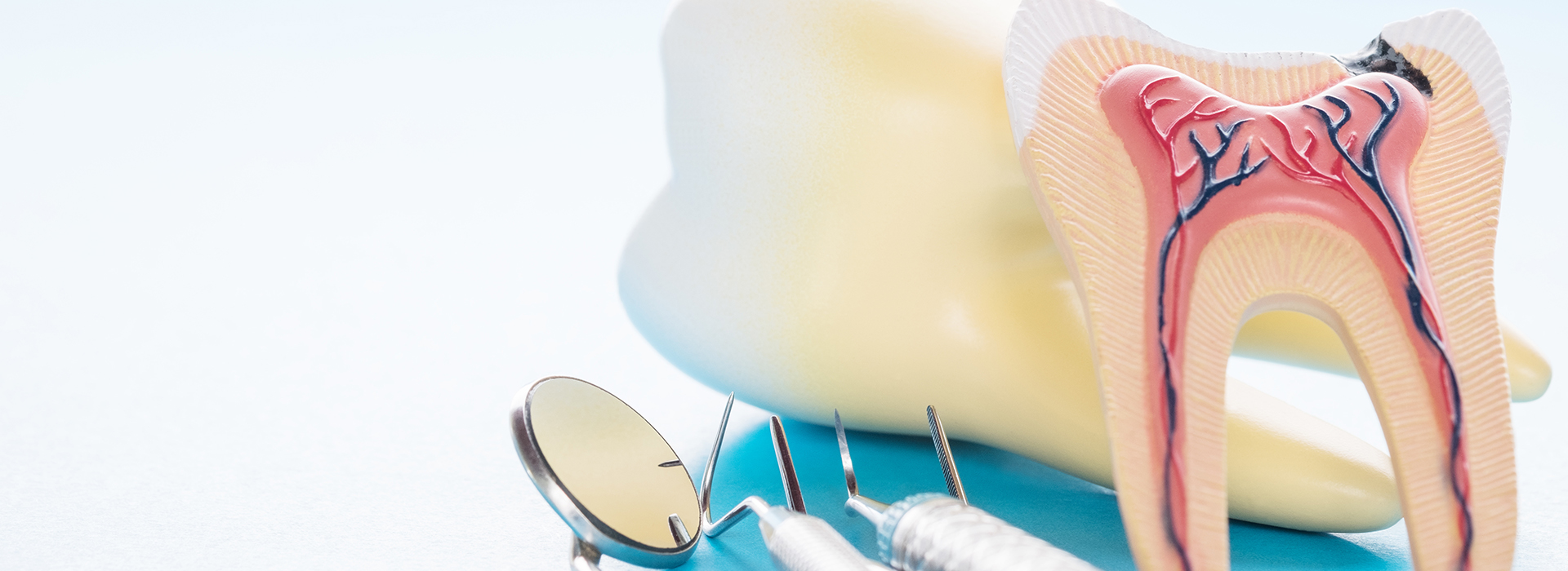 The image displays a close-up view of dental tools including a toothbrush, dental floss, and possibly other dental hygiene items, with a focus on oral health care.